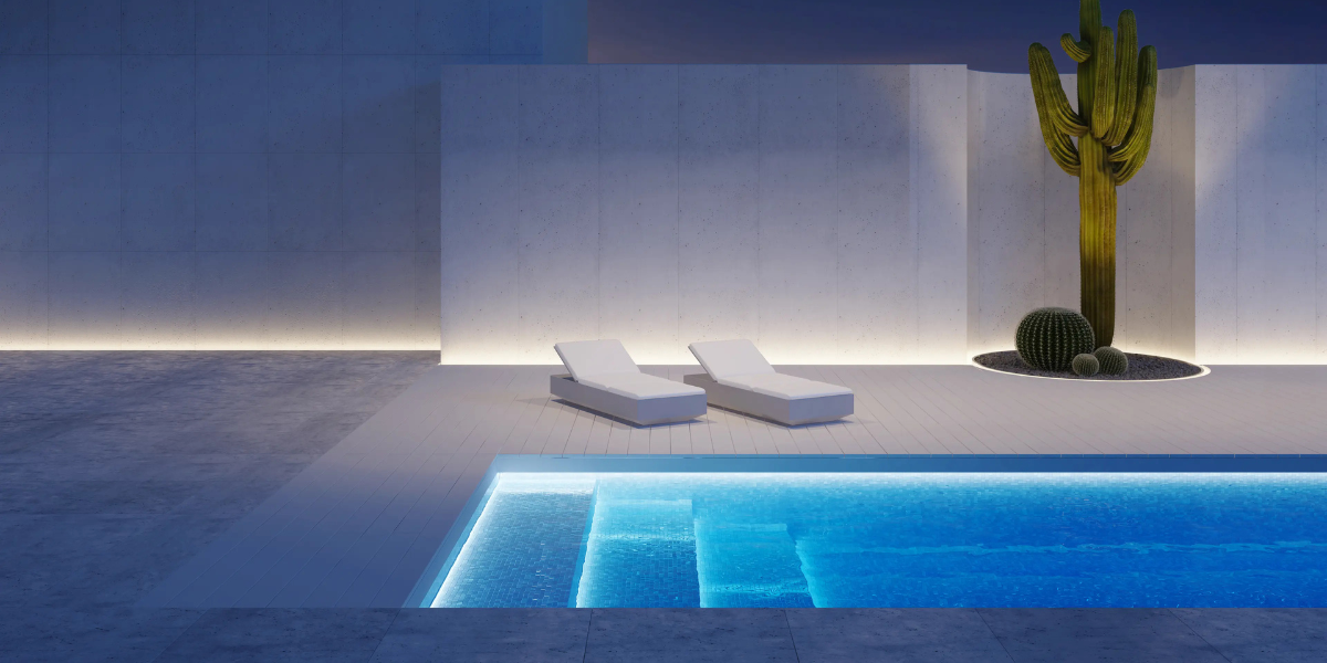 Piscine design illuminée avec projecteurs installés en saillie, illustrant la gamme Poolplanet de projecteurs faciles à poser pour un éclairage moderne et uniforme de la piscine et de ses abords.
